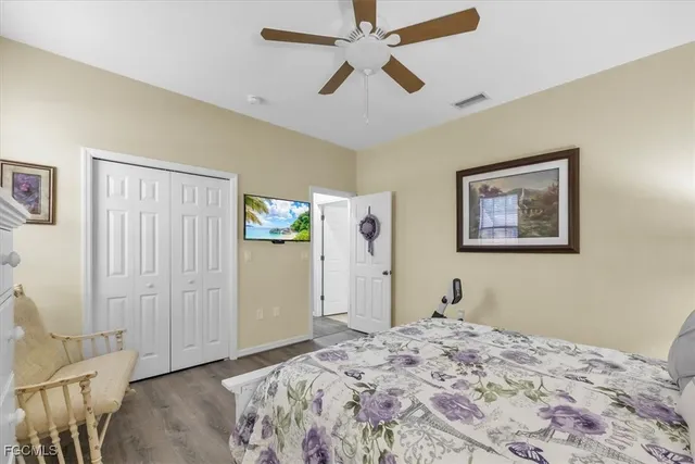 a bedroom with bed and wooden floor