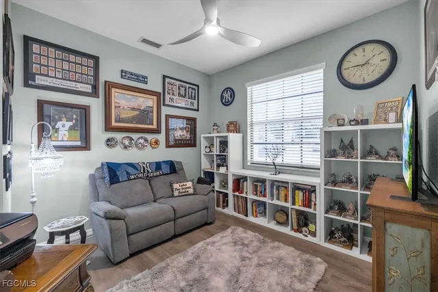 a living room with furniture a window and a bookshelf