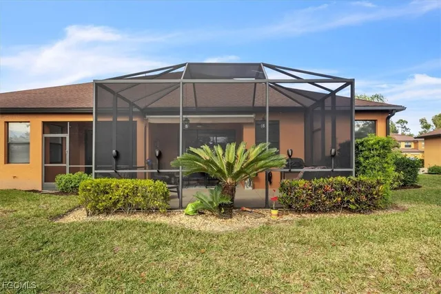 a view of a house with a small yard and plants