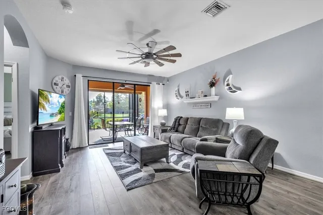 a living room with furniture a large window and a flat screen tv