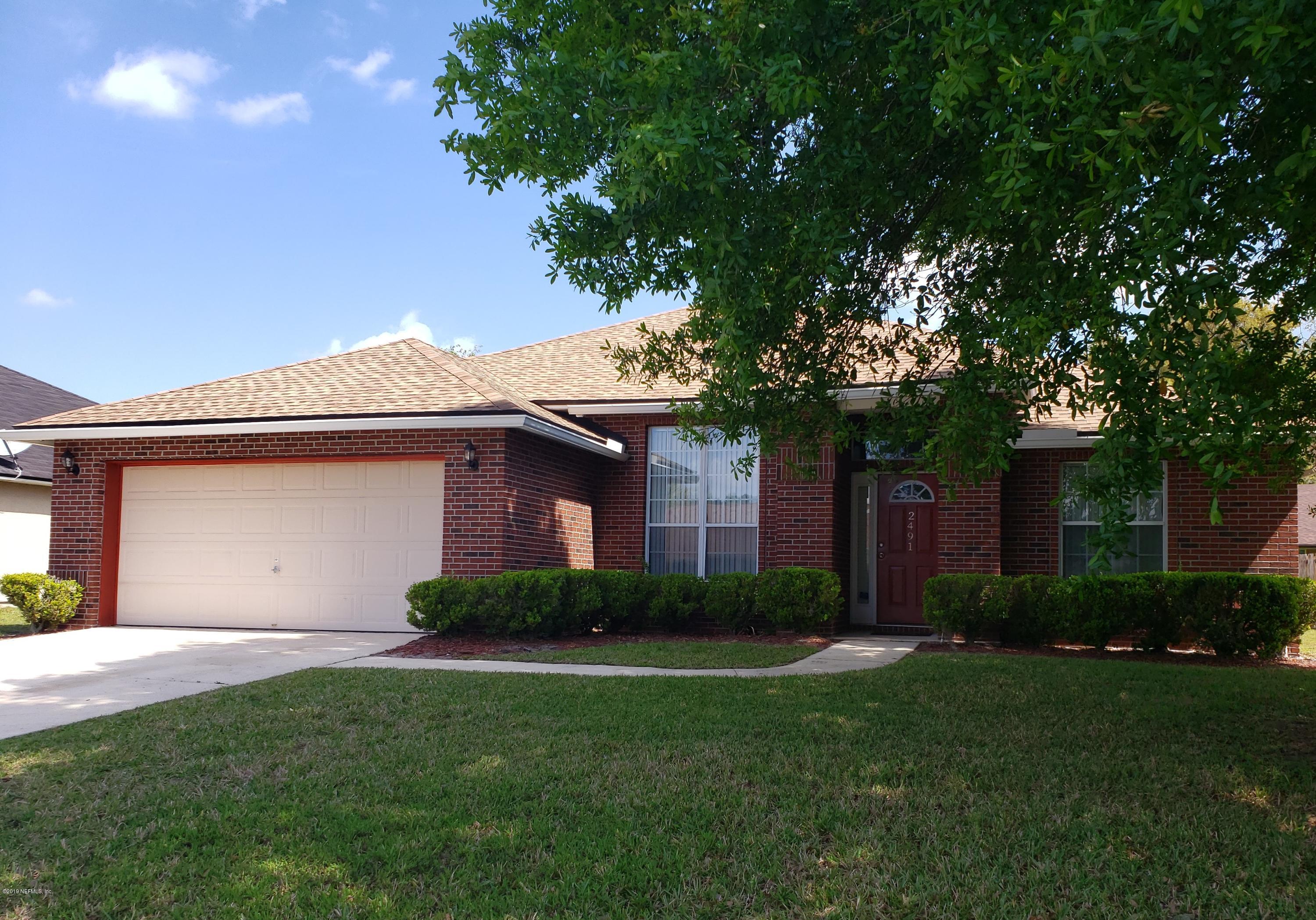 2491 Paris Mill Road Jacksonville, FL 32221 - Photo 1 of 1 a front view of a house with a garden and plants