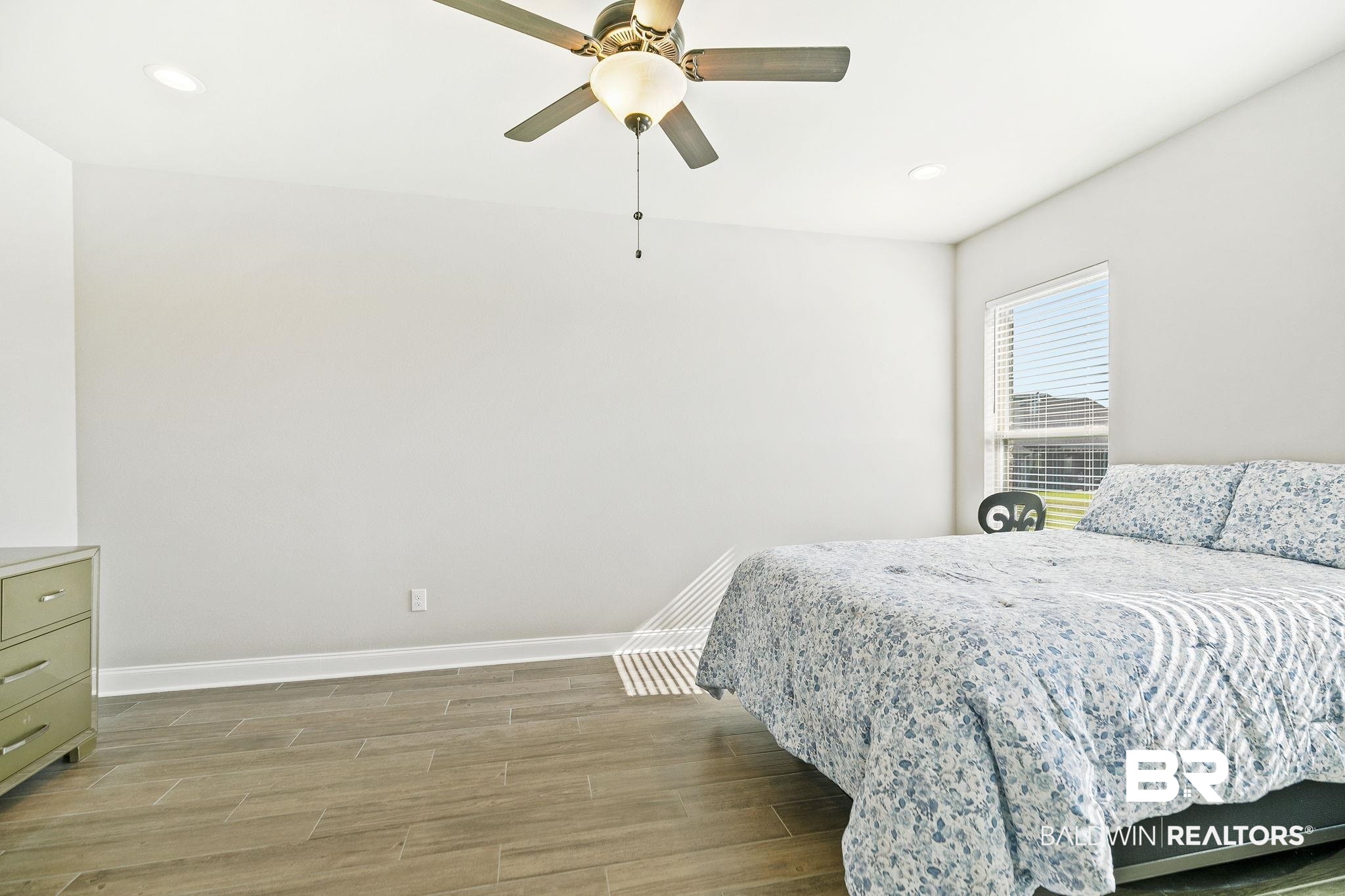 10140 Chipper Lane Foley, AL 36535 - Photo 28 of 72 Bedroom with ceiling fan and hardwood / wood-style floors
