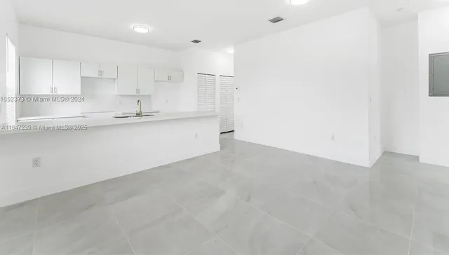 a backyard of a house with plants and entertaining space