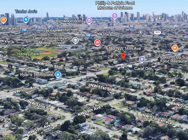 a view of a white house with a big yard and large trees