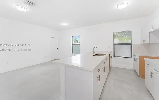 a kitchen with a sink and cabinets