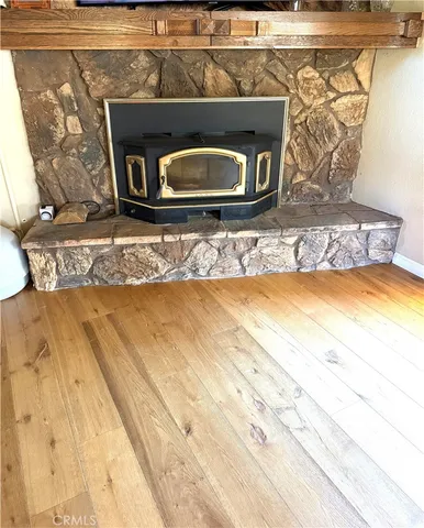 a front view of a fireplace with wooden floor