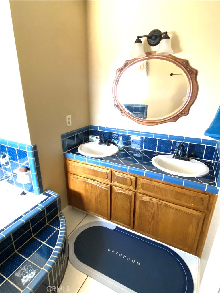 984 Pinon Road Pinon Hills, CA 92372 - Photo 18 of 45 a bathroom with a sink and a mirror