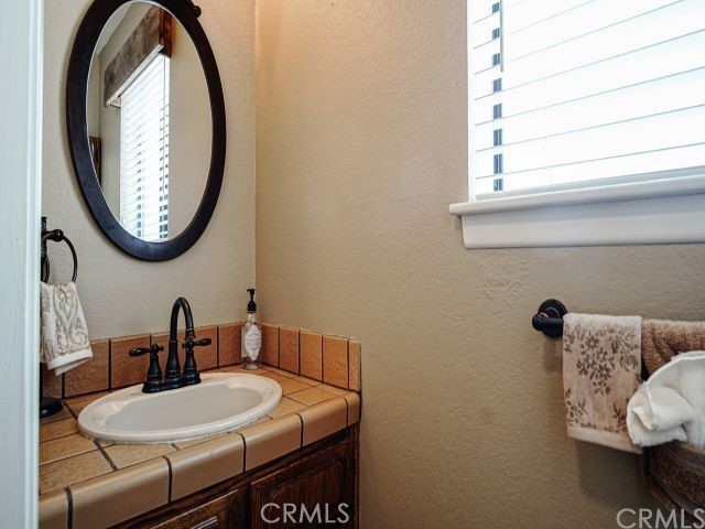 984 Pinon Road Pinon Hills, CA 92372 - Photo 22 of 45 a bathroom with a sink and a mirror