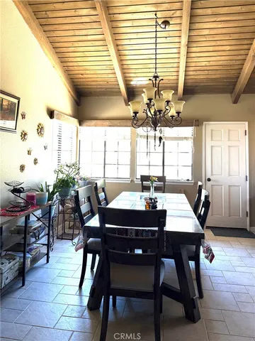 a dining room with a large window table and chairs