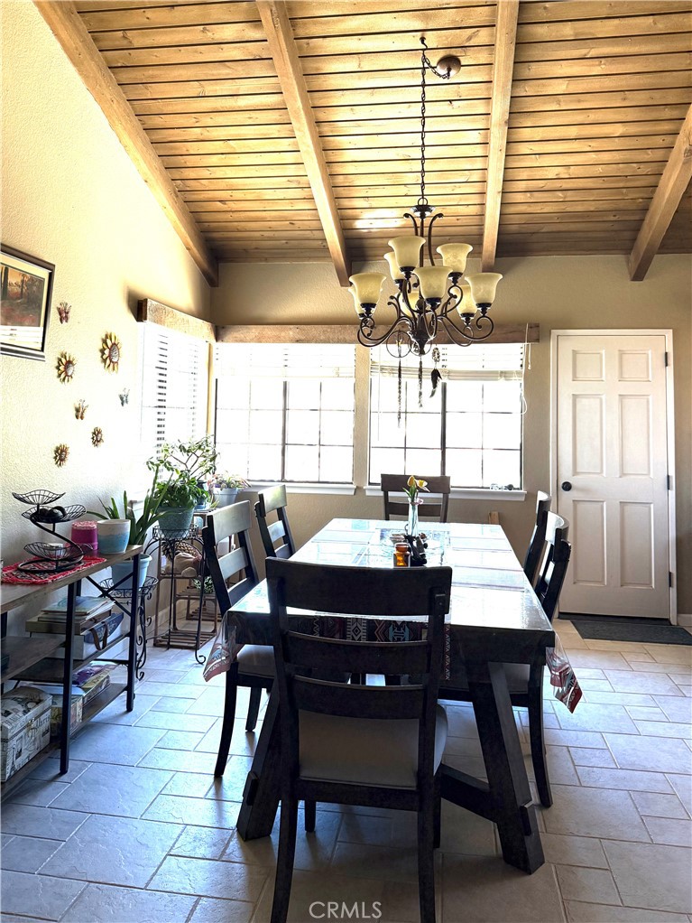 984 Pinon Road Pinon Hills, CA 92372 - Photo 23 of 45 a dining room with a large window table and chairs