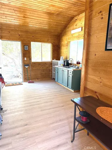 a room with wooden floor and furniture