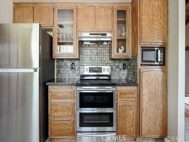 984 Pinon Road Pinon Hills, CA 92372 - Photo 6 of 45 a kitchen with stainless steel appliances granite countertop a stove a refrigerator and a microwave