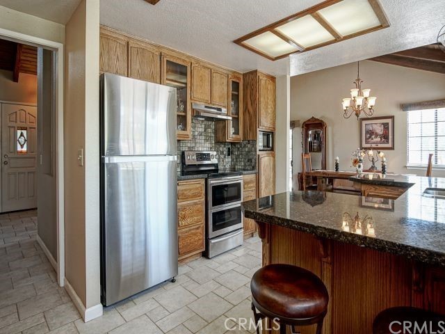 984 Pinon Road Pinon Hills, CA 92372 - Photo 7 of 45 a kitchen with refrigerator and cabinets