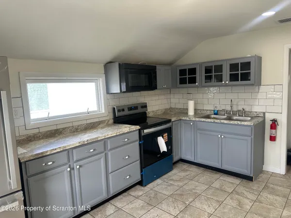 a kitchen with sink cabinets and window