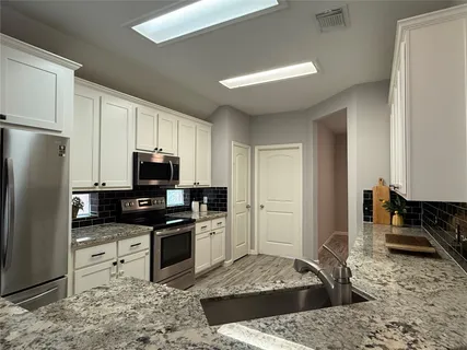 a kitchen with a refrigerator sink and stove