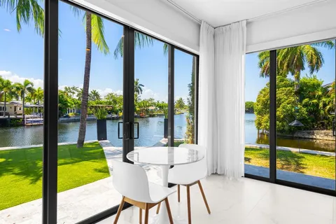 a view of a swimming pool with chairs in patio