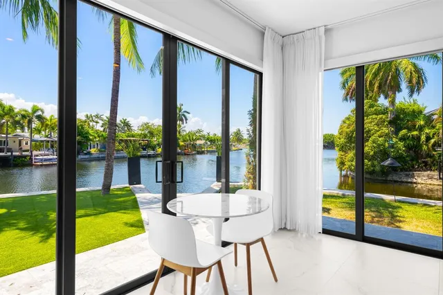 a view of a swimming pool with chairs in patio
