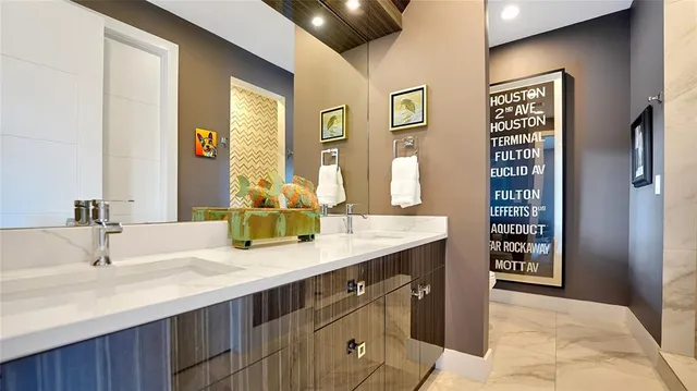 a bathroom with double vanity sinks a shower and a mirror