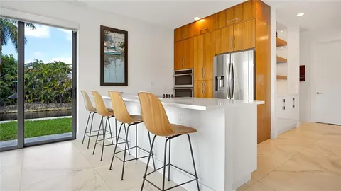 a dining room with furniture and a floor to ceiling window