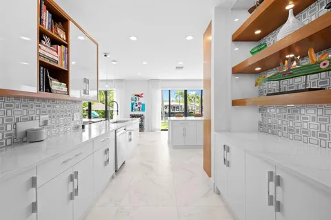 a large white kitchen with stainless steel appliances