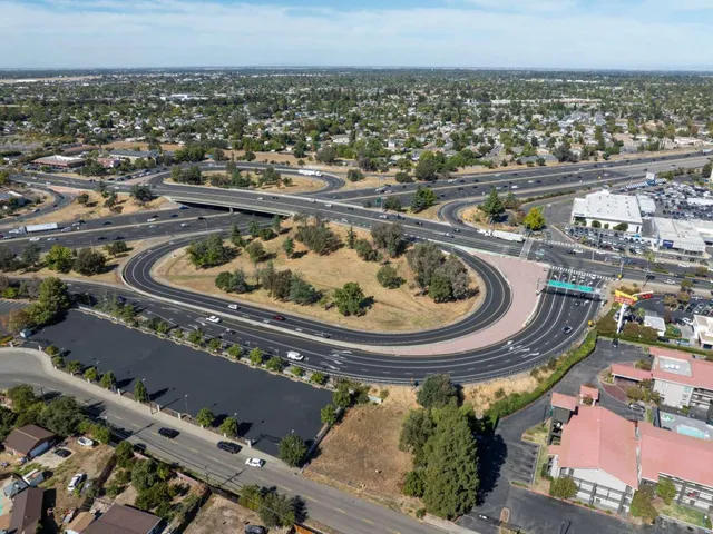 an aerial view of a residential houses with city view