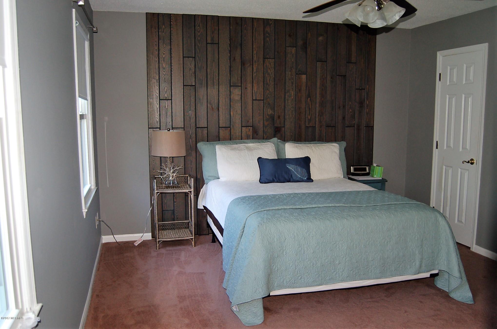 706 Stately Pines Road New Bern, NC 28560 - Photo 15 of 28 Custom wood wall adds a bit of flair to the room.