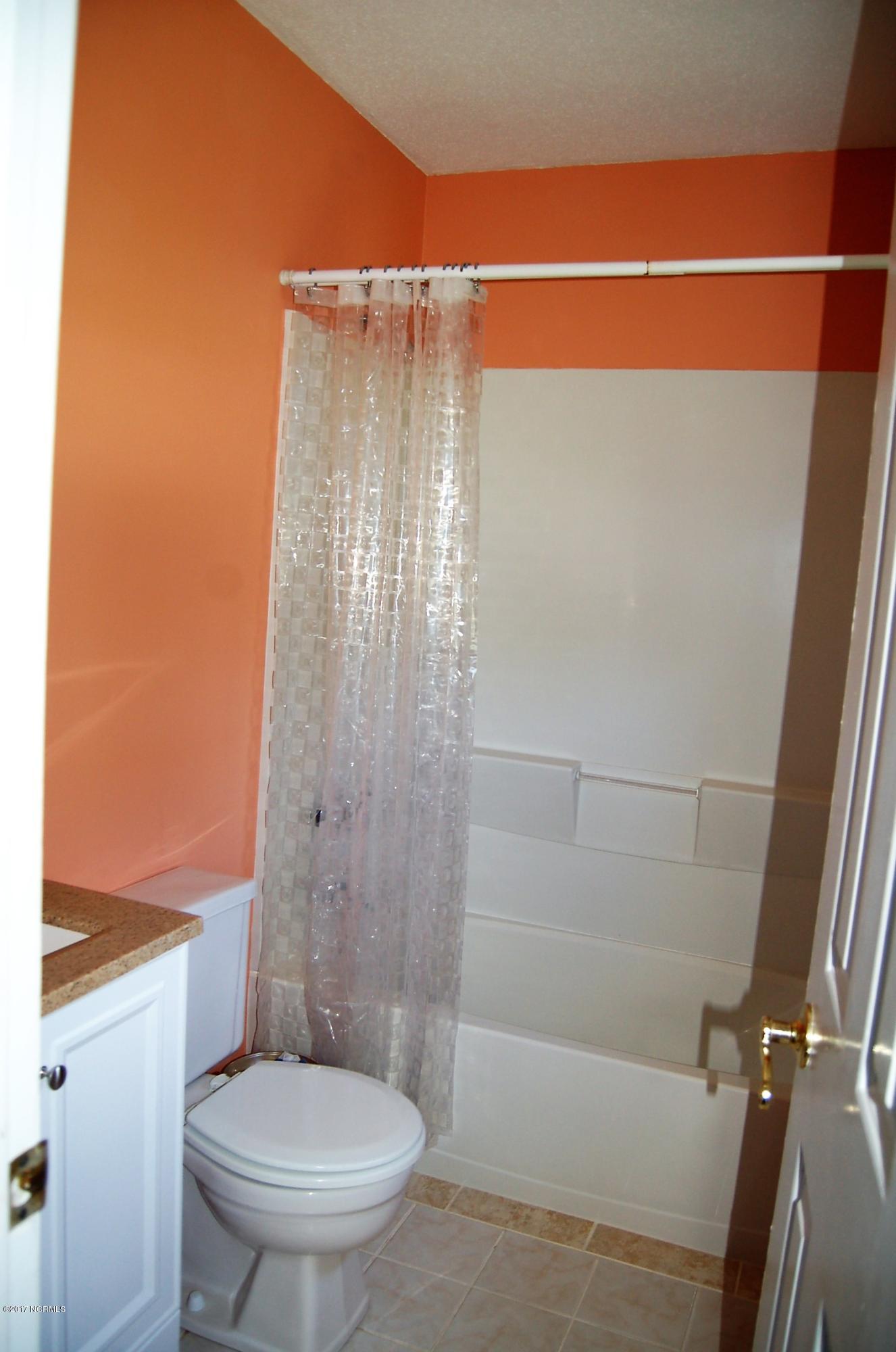 706 Stately Pines Road New Bern, NC 28560 - Photo 16 of 28 The principle bath has been updated with tile floor, new mirror, new vanity and lighting