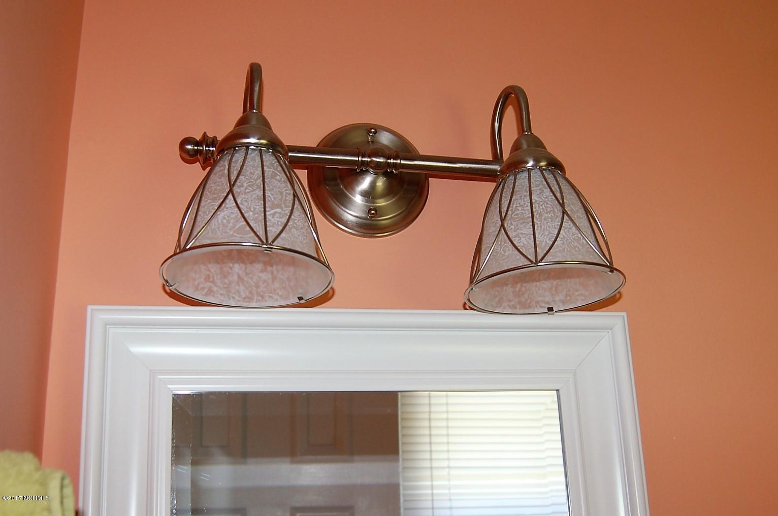 706 Stately Pines Road New Bern, NC 28560 - Photo 17 of 28 Beautiful custom lights in the Principle bath.