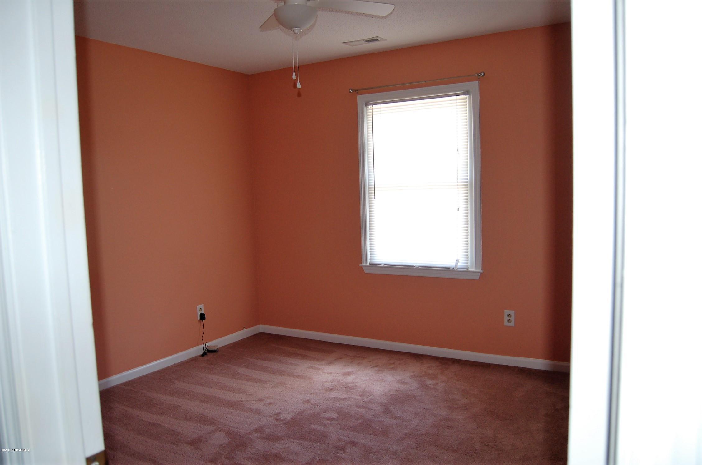 706 Stately Pines Road New Bern, NC 28560 - Photo 19 of 28 Nice size bedroom with carpet, ceiling fan and large closet.