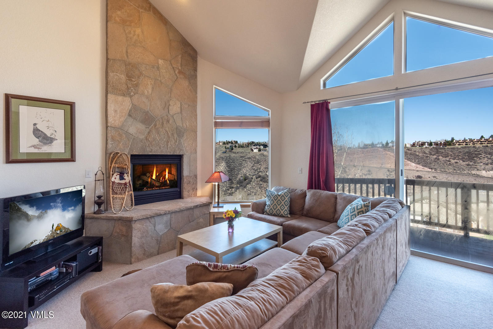 a living room with furniture a flat screen tv and a fireplace