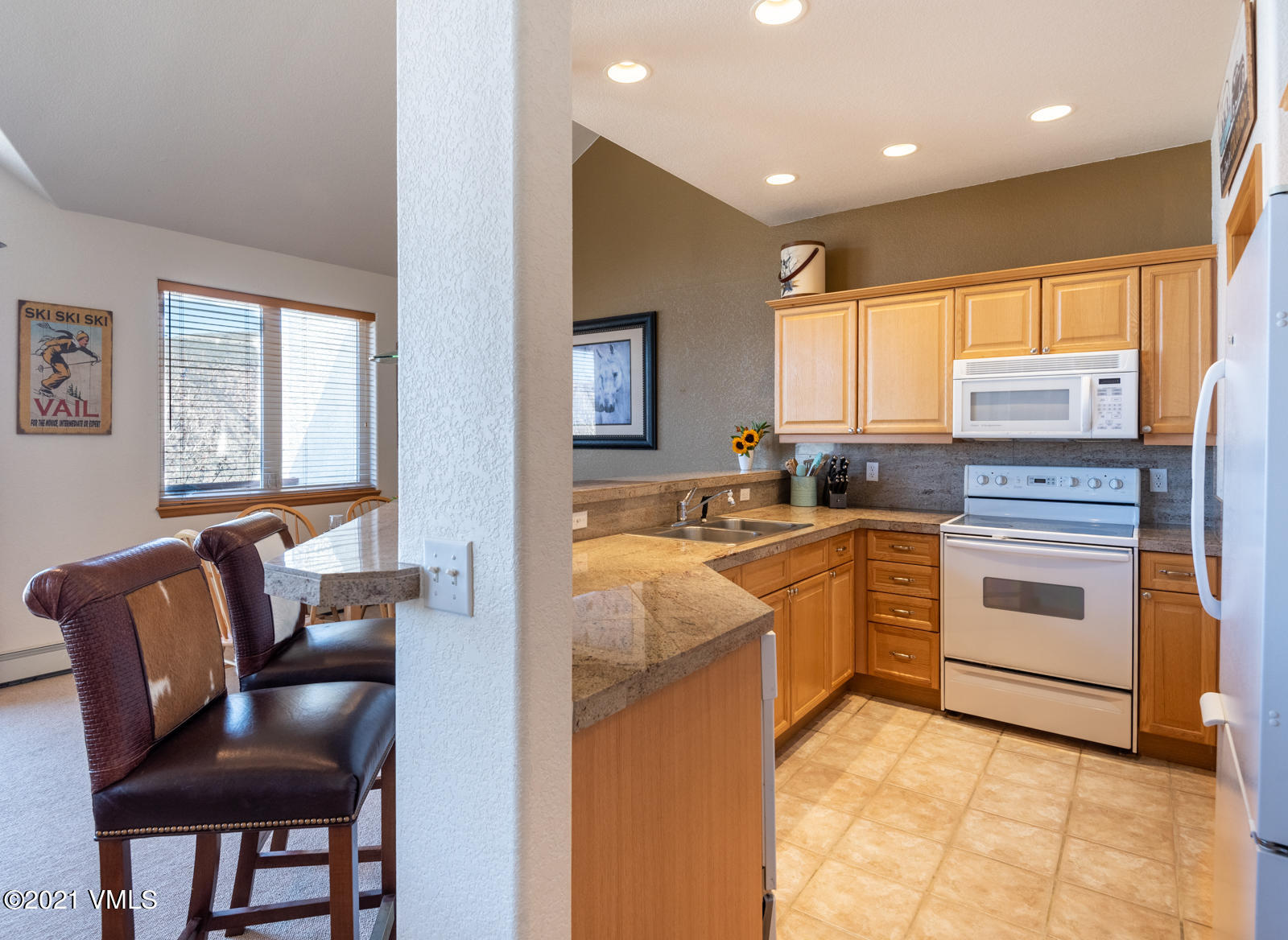 1082 West Wildwood Road, Unit C Avon, CO 81620 - Photo 11 of 30 a kitchen with white cabinets and appliances