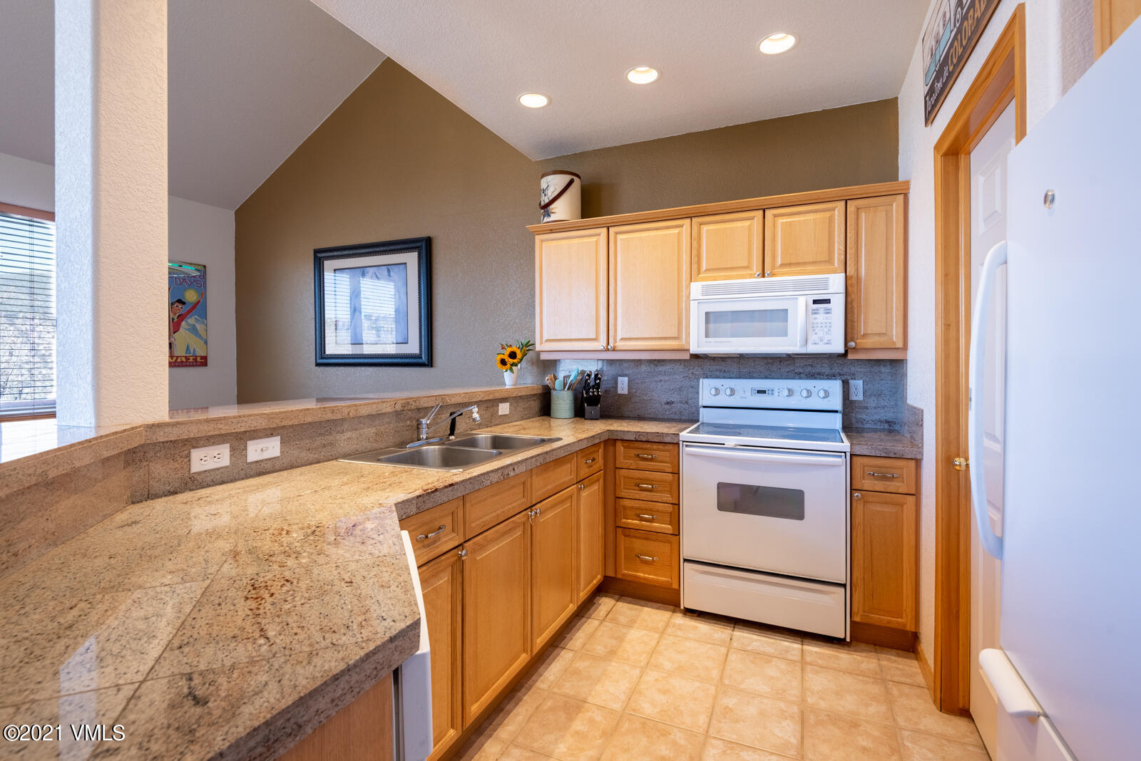 1082 West Wildwood Road, Unit C Avon, CO 81620 - Photo 12 of 30 a kitchen with a sink stove and refrigerator