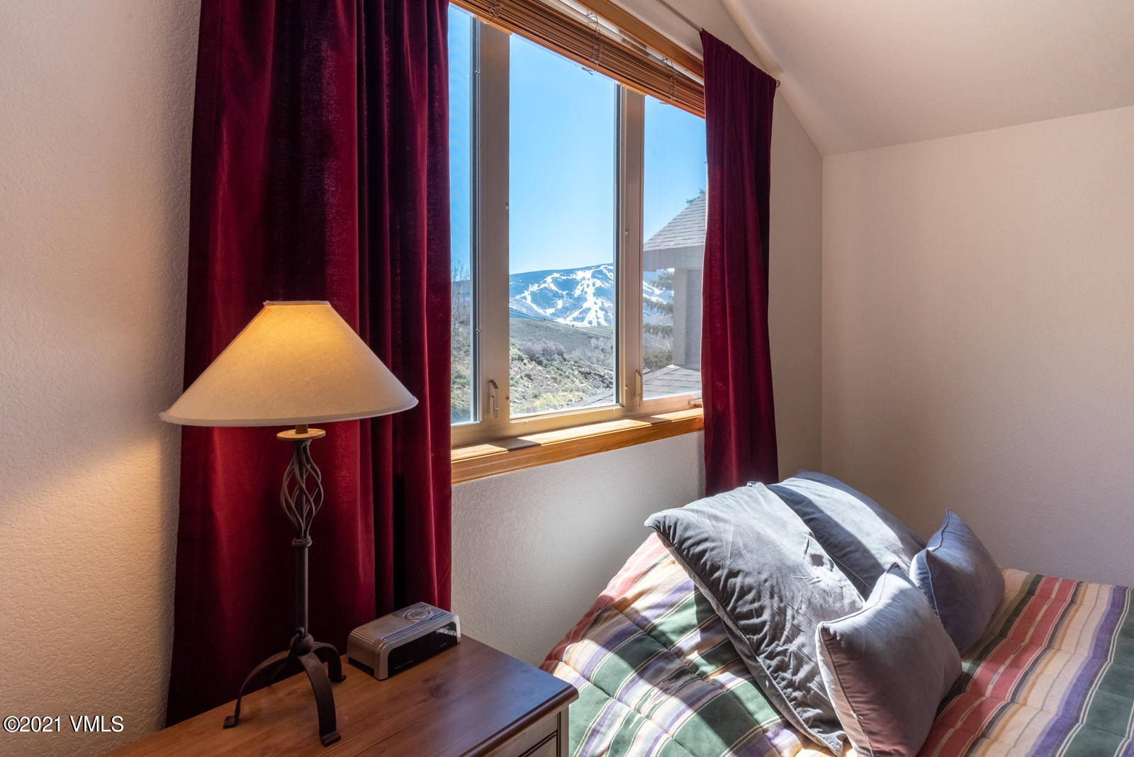 1082 West Wildwood Road, Unit C Avon, CO 81620 - Photo 15 of 30 a bedroom with a bed and a window