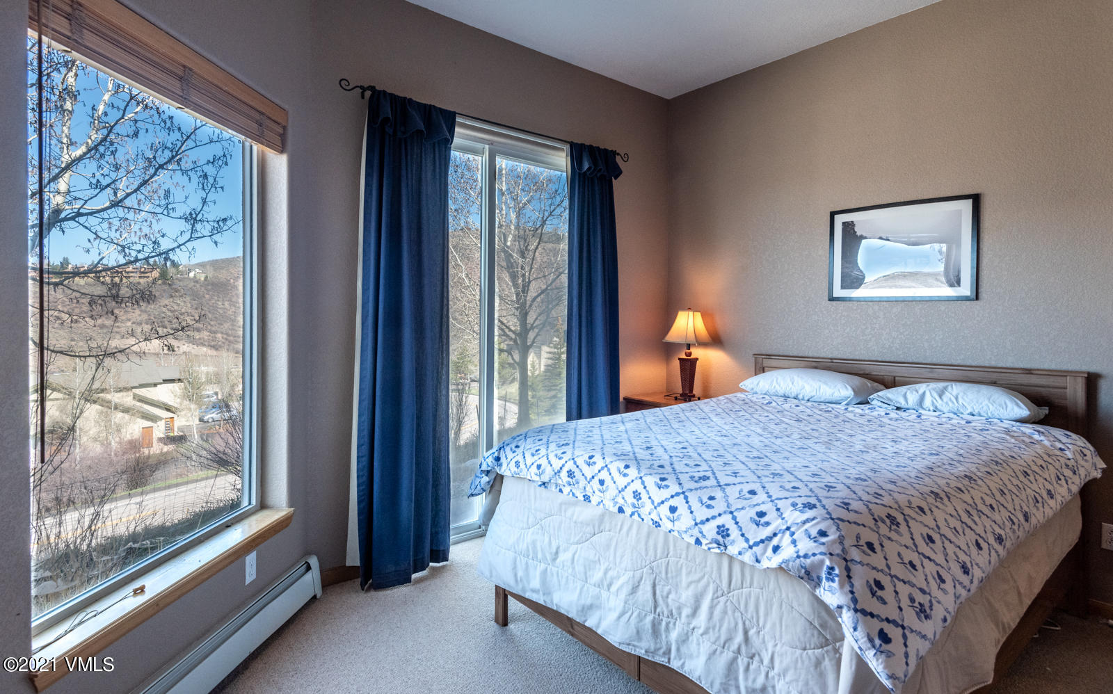 1082 West Wildwood Road, Unit C Avon, CO 81620 - Photo 22 of 30 a bedroom with a bed and a painting on the wall