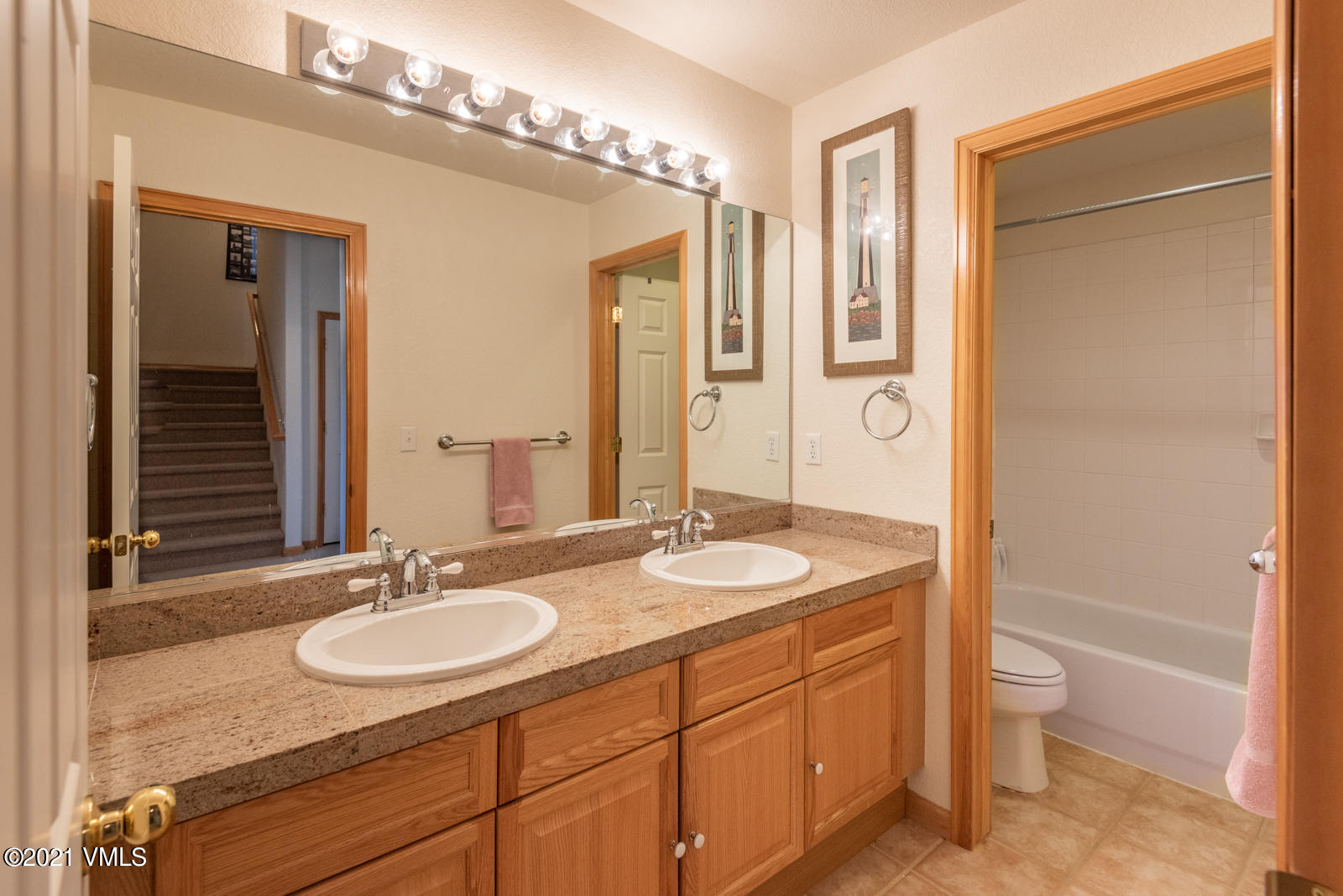 1082 West Wildwood Road, Unit C Avon, CO 81620 - Photo 23 of 30 a bathroom with a granite countertop sink and a mirror