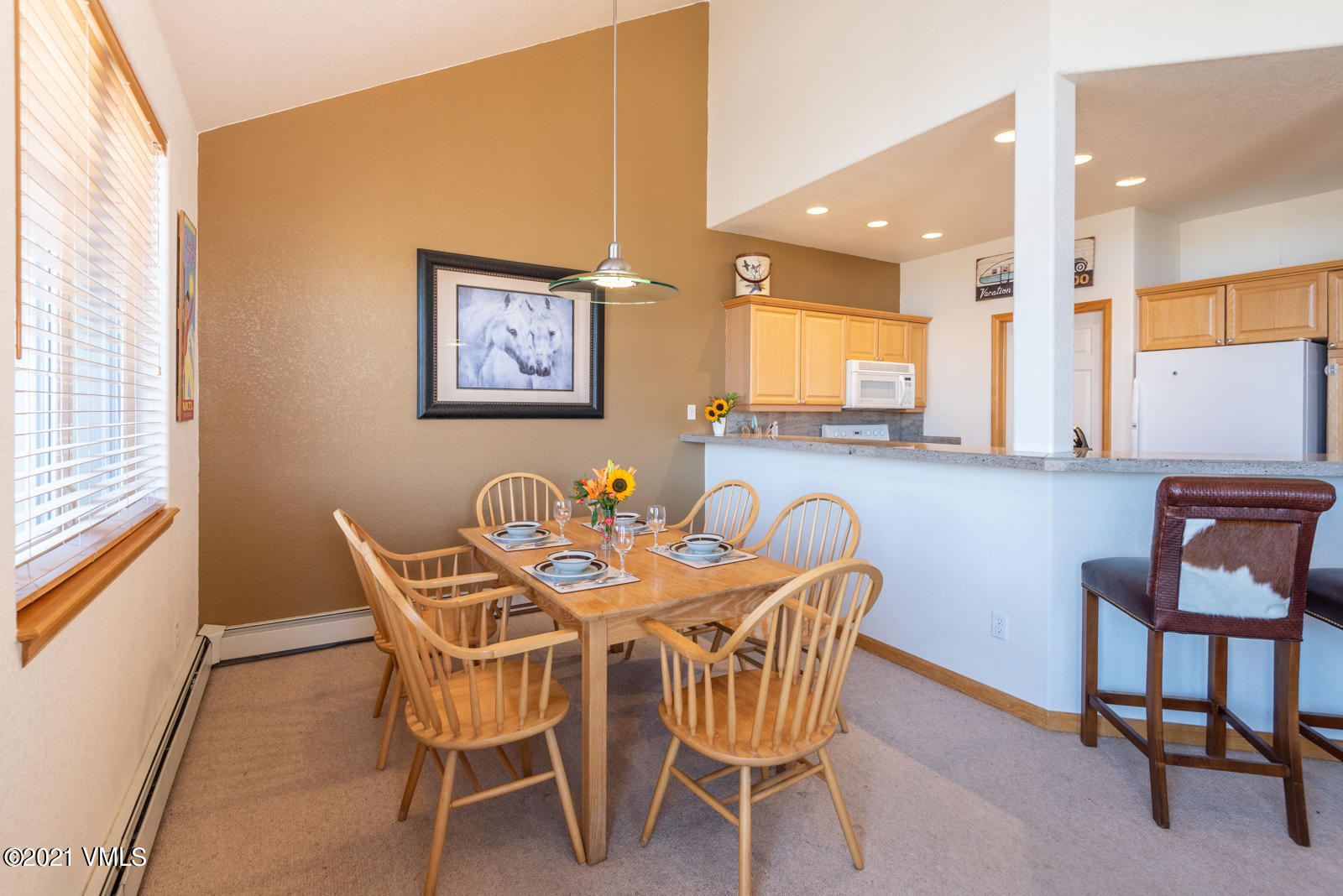 1082 West Wildwood Road, Unit C Avon, CO 81620 - Photo 9 of 30 a view of a dining room with furniture and a window