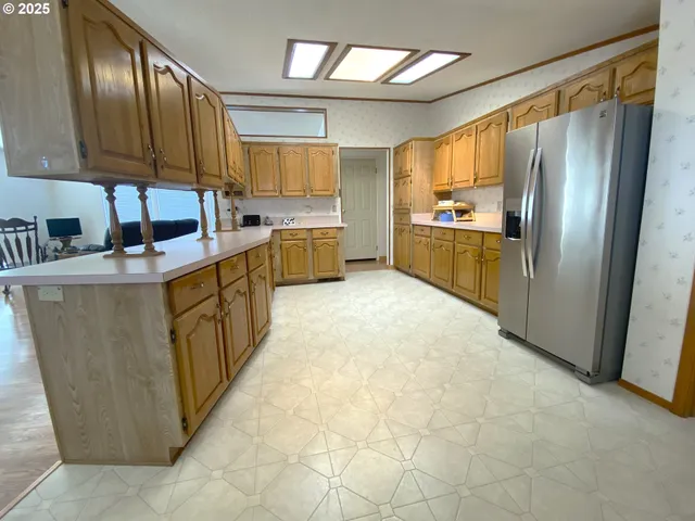 a kitchen with granite countertop a sink counter top space appliances and cabinets