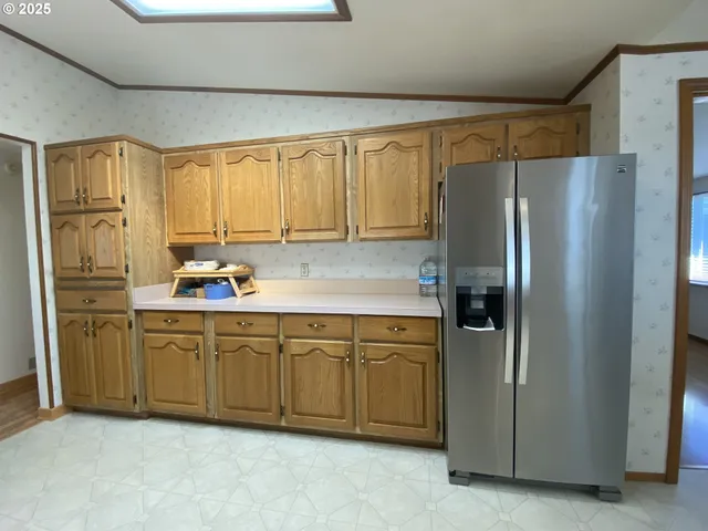 a kitchen with a sink appliances and cabinets