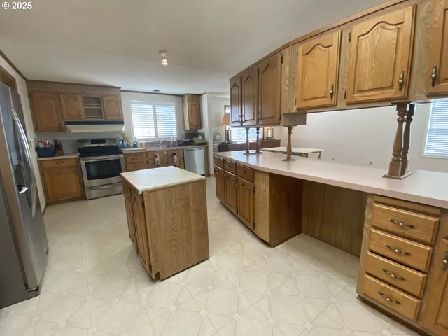 a kitchen with stainless steel appliances granite countertop a sink and a cabinets