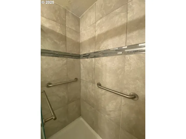 a spacious bedroom with a bed and wooden floor