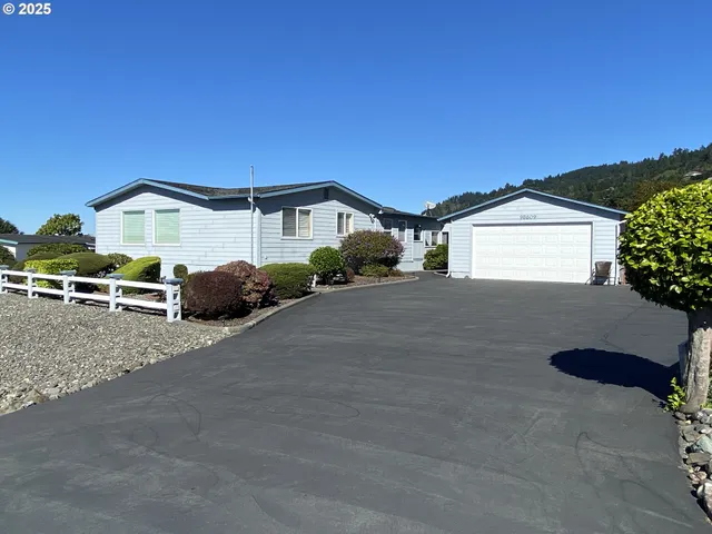 an aerial view of a town with residential houses and lake view