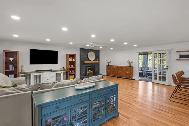 a living room with furniture flat screen tv and wooden floor