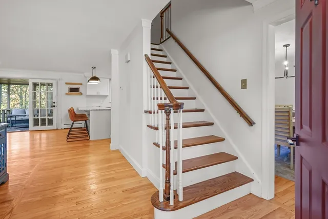 a view of entryway and hall with wooden floor