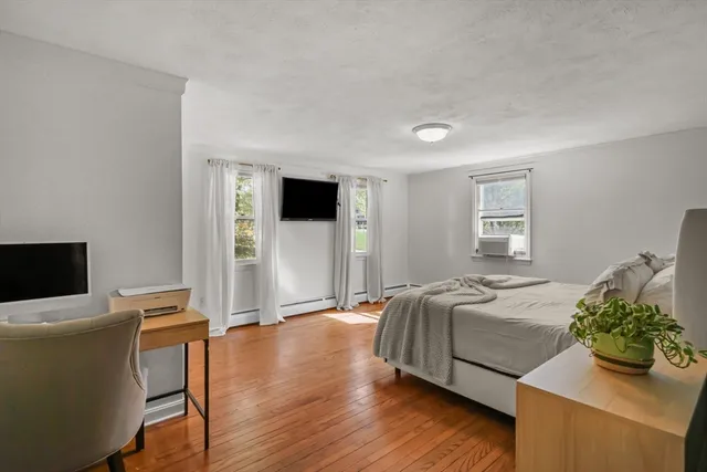 a bedroom with a bed and a television