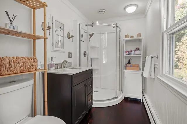 a bathroom with a granite countertop sink toilet and shower