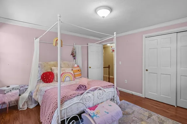 a bedroom with a bed dresser and a window