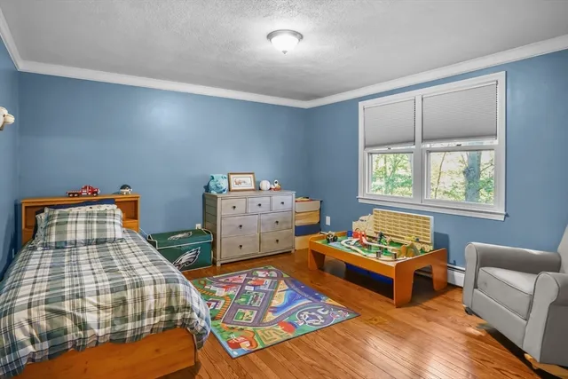 a bedroom with two beds and a window