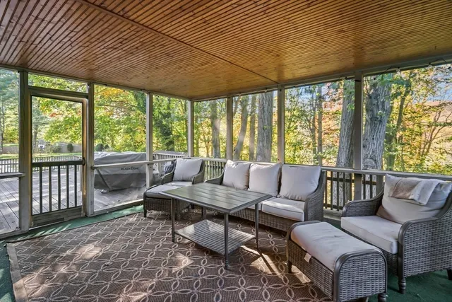 a living room with furniture and a floor to ceiling window
