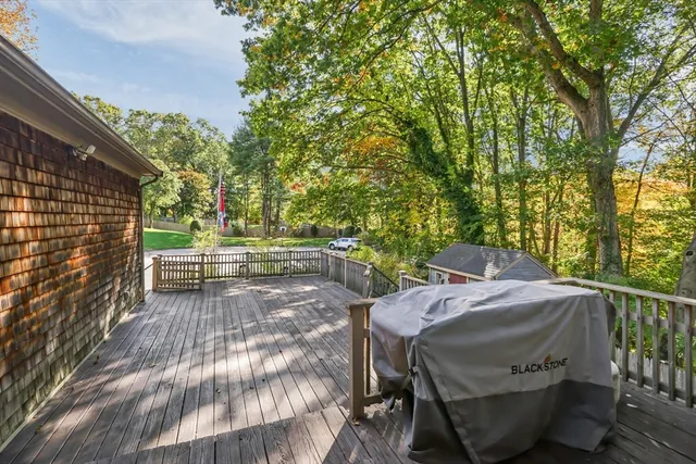 a view of backyard with outdoor seating and trees