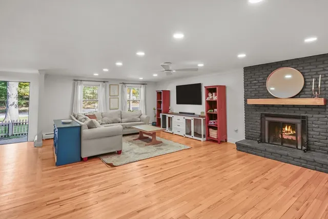 a living room with furniture a fireplace and a flat screen tv